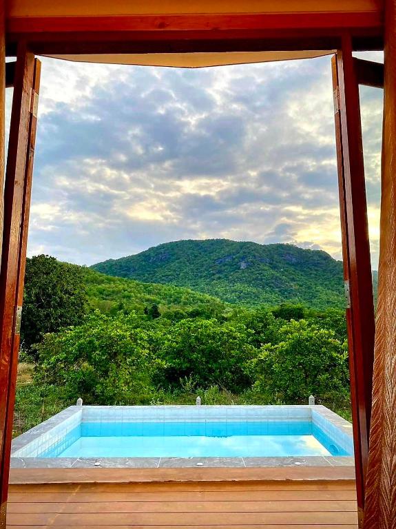 a view of a swimming pool through a window at Tropical pool villa คอฟฟี่มีเขาสาขา2 in HHQ
