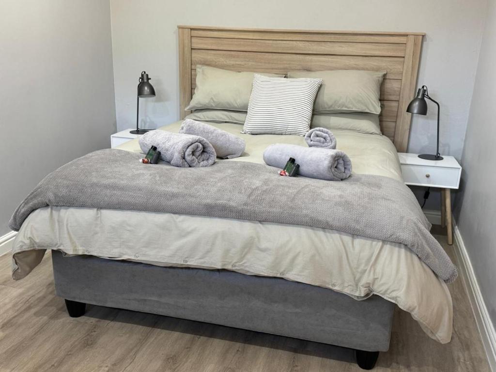 a bedroom with a bed with two stuffed animals on it at Alicante in Worcester