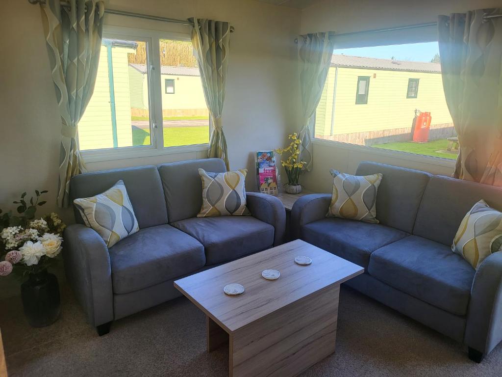 a living room with a couch and a coffee table at Nidd Way Holiday Let in Knaresborough