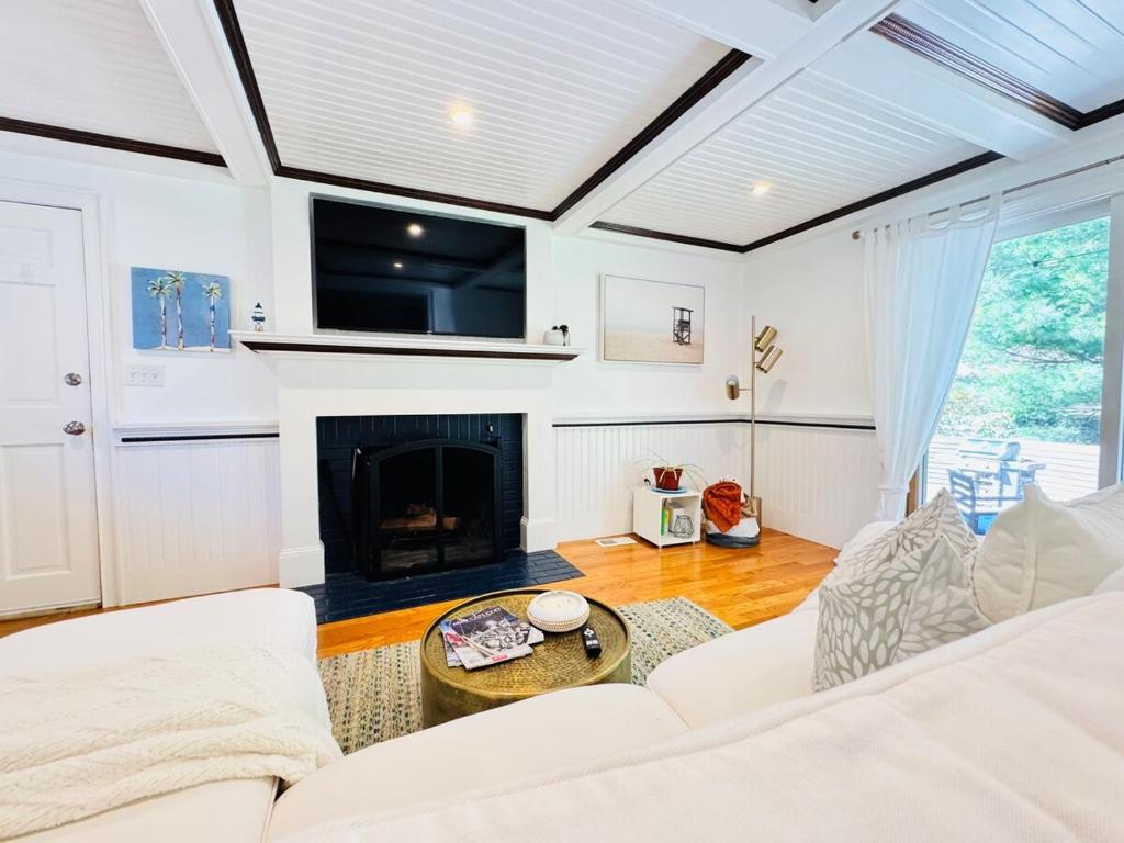 a living room with a couch and a fireplace at Cape Cod Retreat, Osterville Beach Pass in Osterville