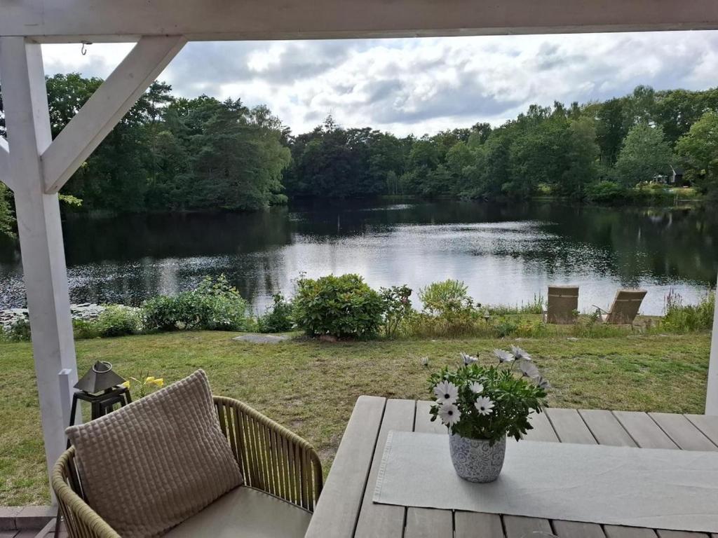 a view of a lake from the porch of a house at Ferienhäuschen blauer See in Bockhorn
