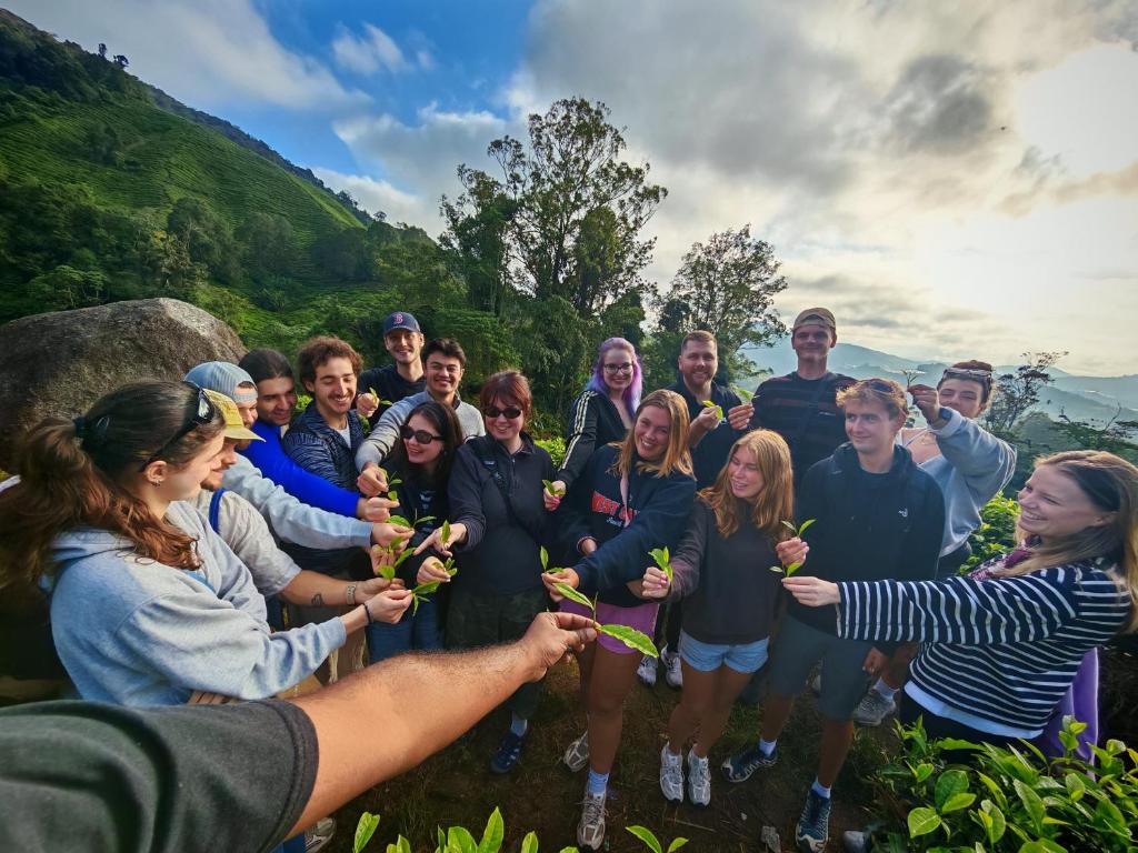 a group of people posing for a picture with flowers at A3A Oastel CoLiving - Children NO Allowed in Tanah Rata