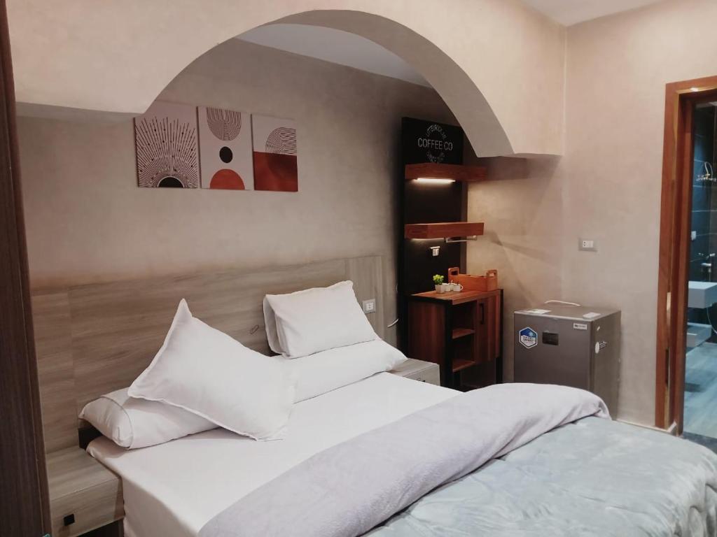 a bedroom with a large bed with white pillows at El Mandara Residence Inn in Alexandria