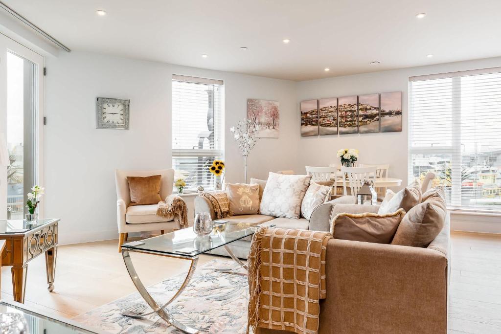 a living room with a couch and a table at Harbours Edge - Front-Line Harbour Views in Poole