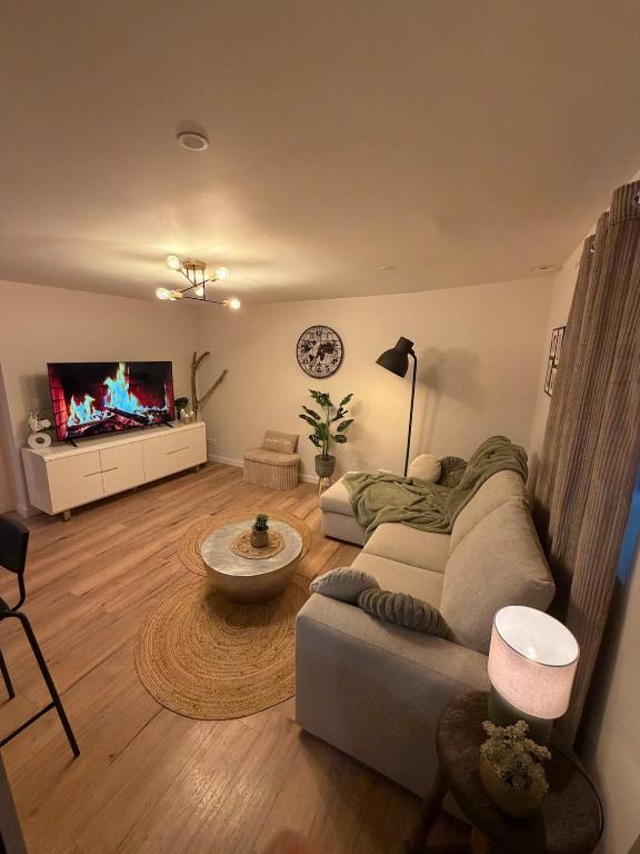 a living room with a couch and a tv at Charmant appartement Chaleureux in Hyères