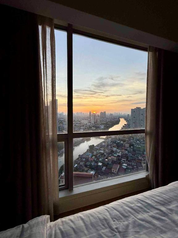 a bedroom window with a view of a city at Novotel at Acqua, The Hotel Residences by RM in Manila