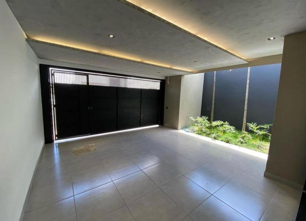 a large empty room with a large window and a large floor at Refúgio Tranquilo in Salvador