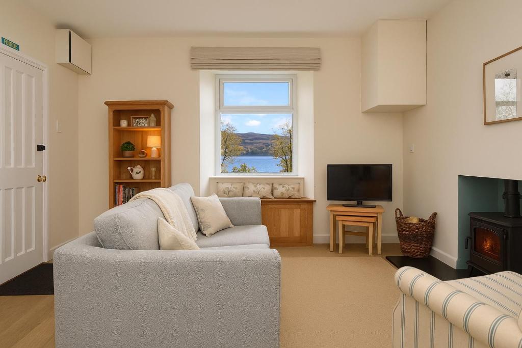 a living room with a couch and a window at Seascape in Kames