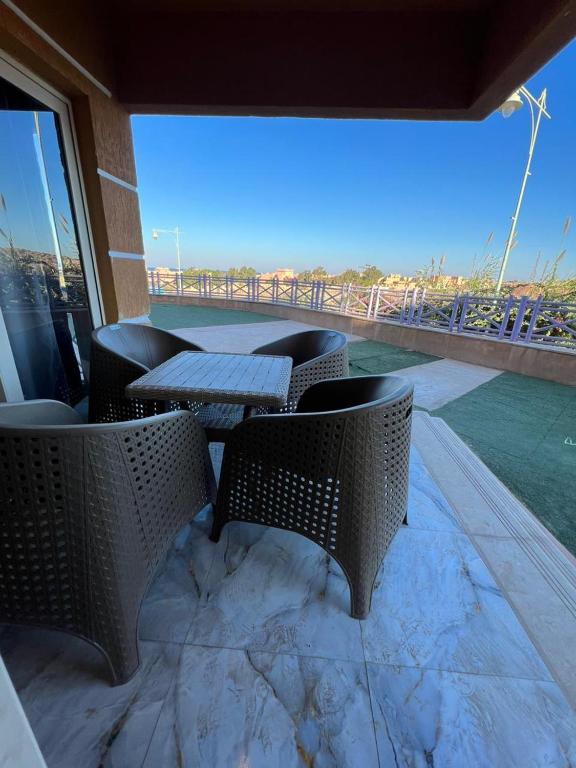 a patio with a table and chairs on a balcony at Front Front Water in Ain Sokhna