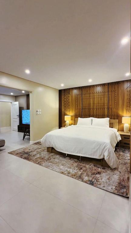 a large bedroom with a large bed and a large rug at AINOSAH Residences in Medina