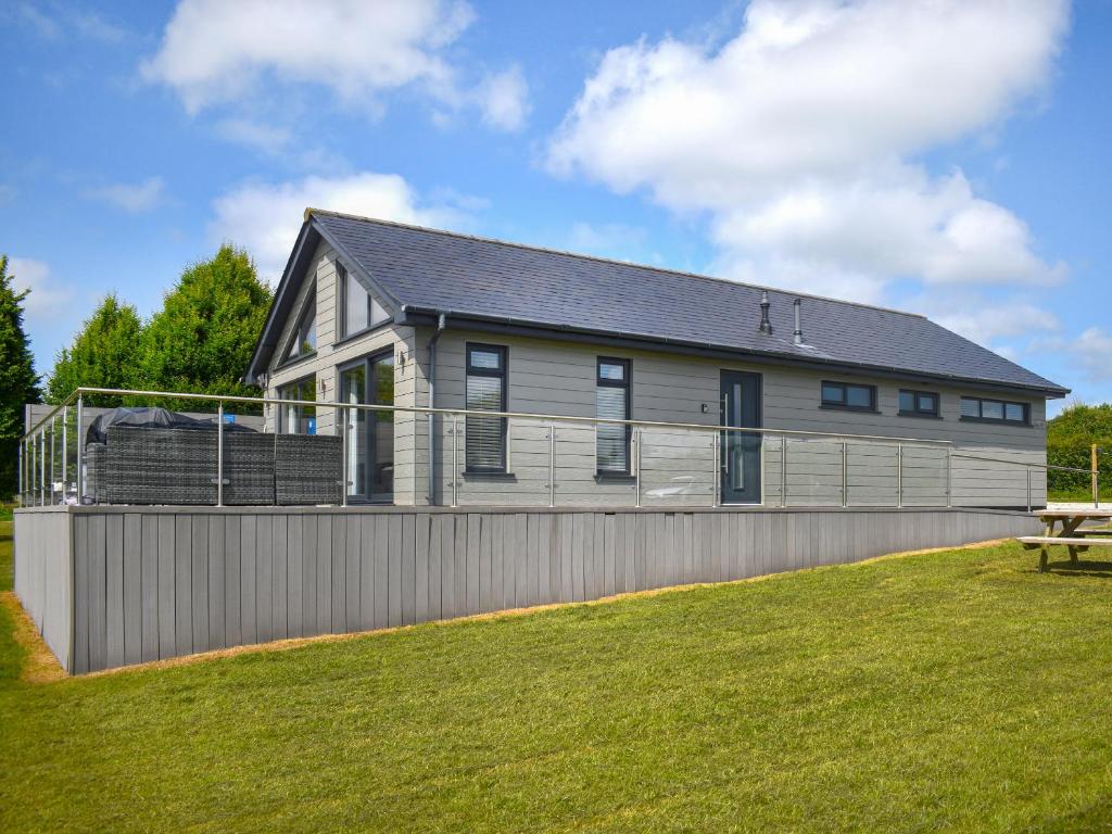 a house on a hill with a fence at Oak Park One - Uk50062 in Tiverton