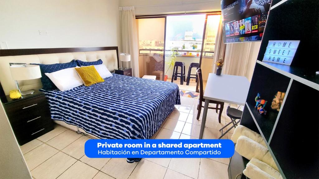 a bedroom with a bed and a dining room with a balcony at Habitación con Baño privado en Departamento Compartido in Lima