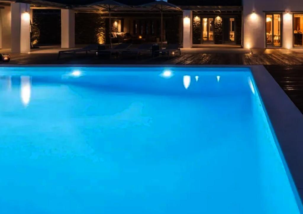 a swimming pool lit up at night at Ios sea view in Ios Chora