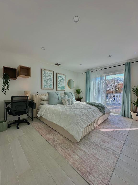 a large bedroom with a large bed and a desk at Arlington Beach House - by Yale in West Haven