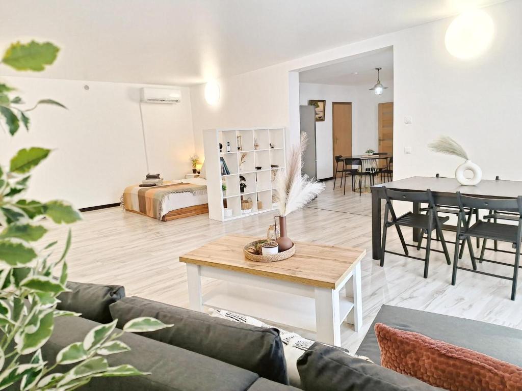 a living room with a couch and a table at Kopų tako apartamentai in Melnragė
