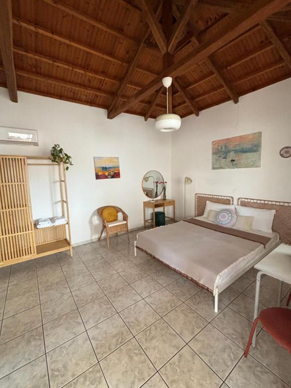 a bedroom with a bed and a wooden ceiling at MARIA 'S LITTLE HOUSE in Patitiri