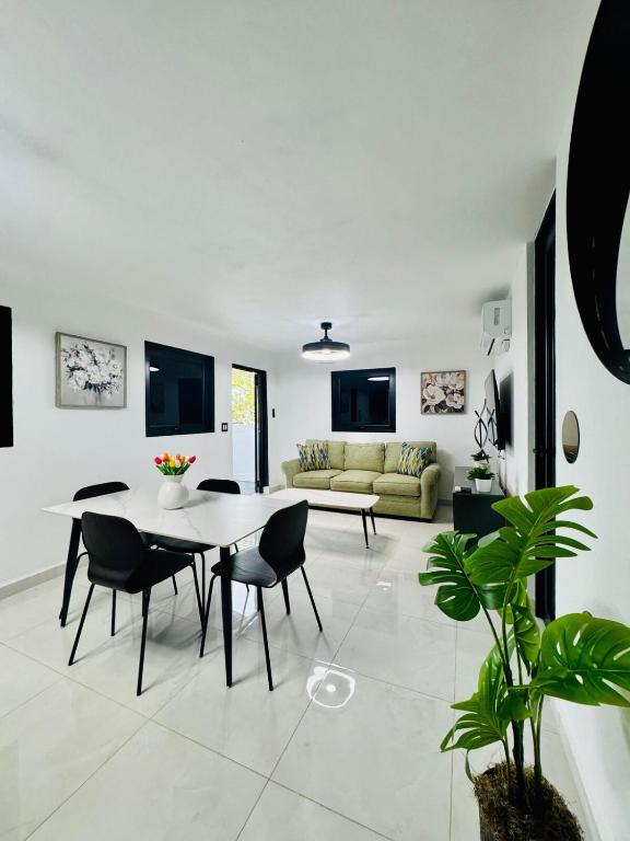 a living room with a table and chairs and a couch at Brand New Luxe Apartment 1 in Carolina