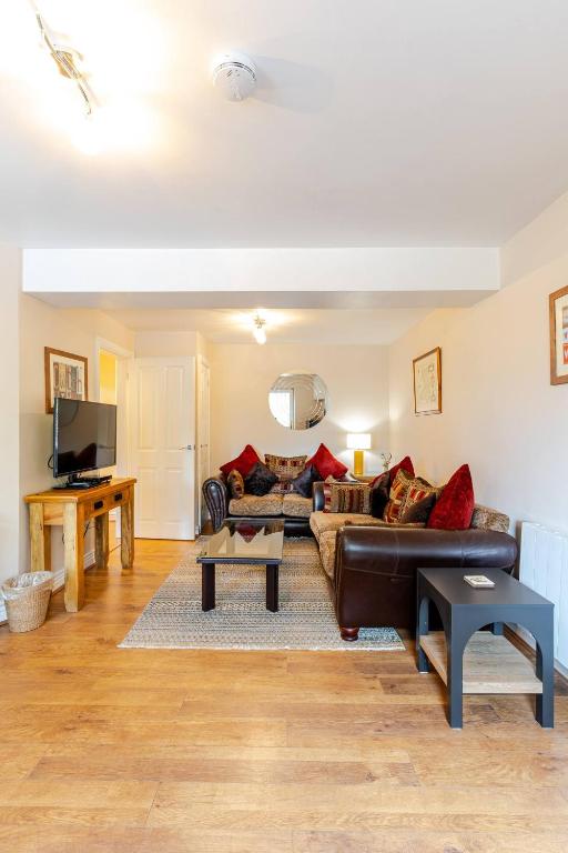 a living room with a couch and a table at Acorns in Holywell