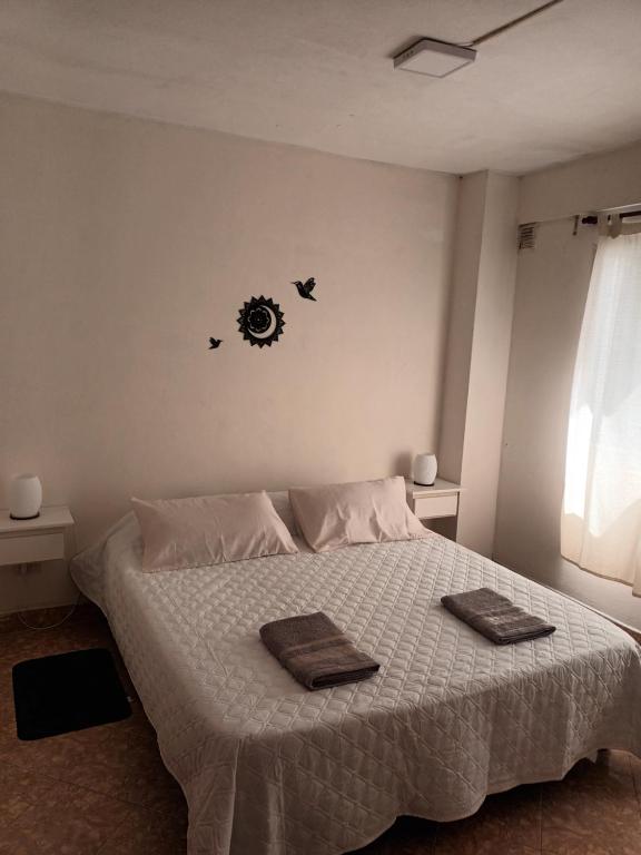 a bedroom with a bed with two towels on it at Casa Serena in Munro