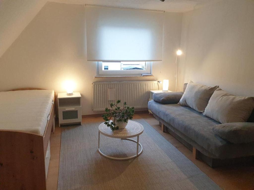 a living room with a couch and a table at Lottes FeWo in Hasselroth
