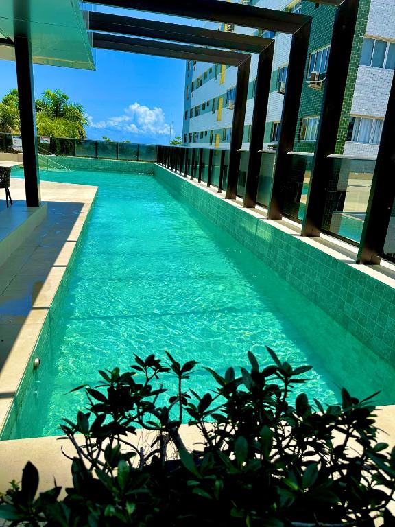 a swimming pool in the middle of a building at Refuge Beira Mar - Boa Viagem in Recife