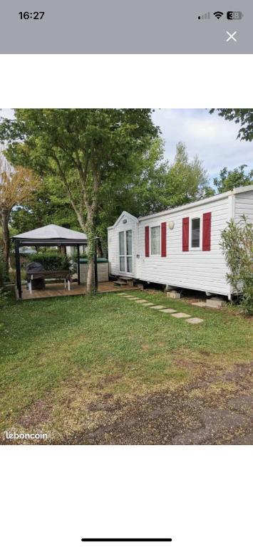 a white mobile home with a gazebo at Lux in Saint-Pierre-dʼOléron