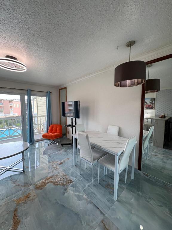 a dining room with a table and chairs at The Galveston Victorian Condo in Galveston