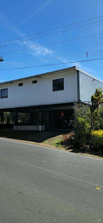 a white building on the side of a street at Fraijanes Mountain Stay in Alajuela