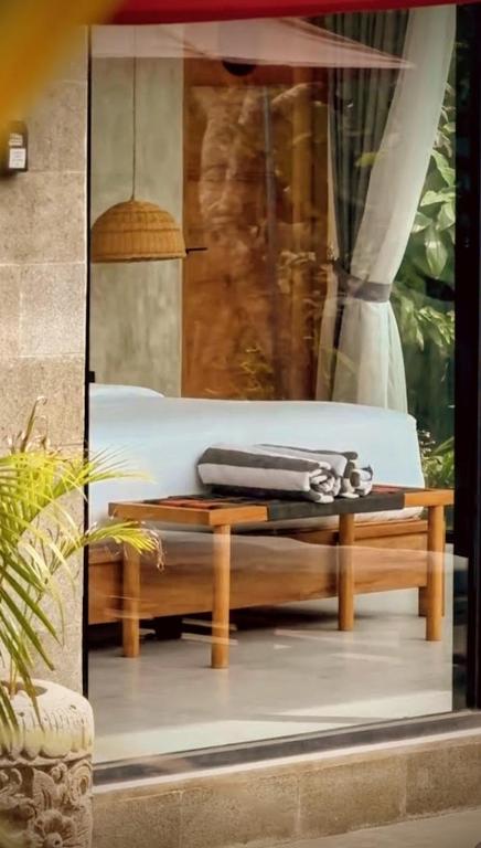 a coffee table in a window of a building at Pigstone Design Studios Beachfront in Tanah Lot