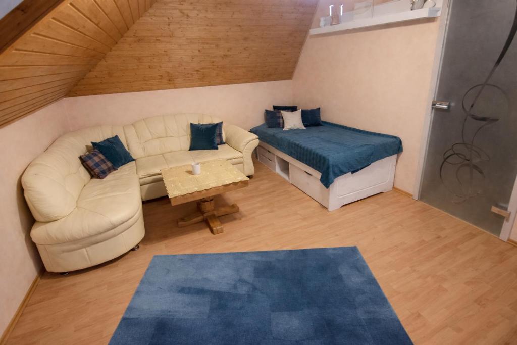 a living room with a couch and a bed at Fewo am Ith in Salzhemmendorf