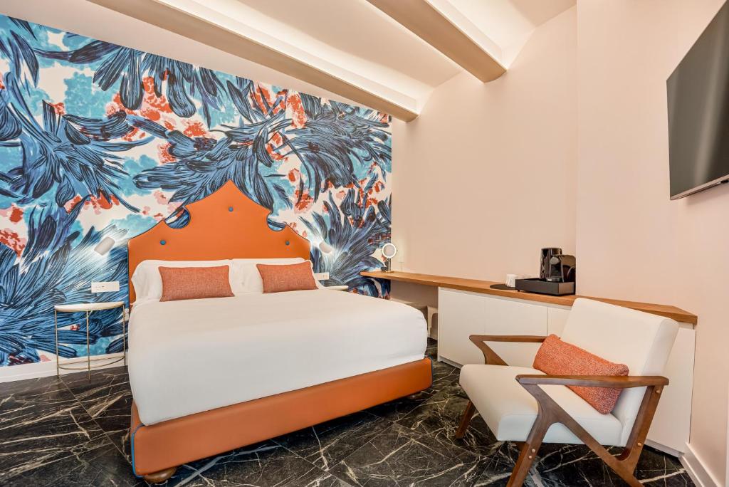 a hotel room with a bed and a chair at Nessun Dorma Suite in Manarola