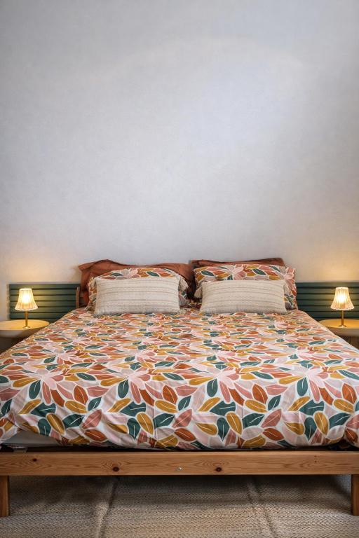 a bed in a room with two pillows on it at Chambre privée, A l'ombre des Pommiers in Croix-Mare