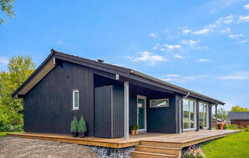 a black tiny house on a wooden deck at 3 Bedroom Awesome Home In Haderslev in Haderslev