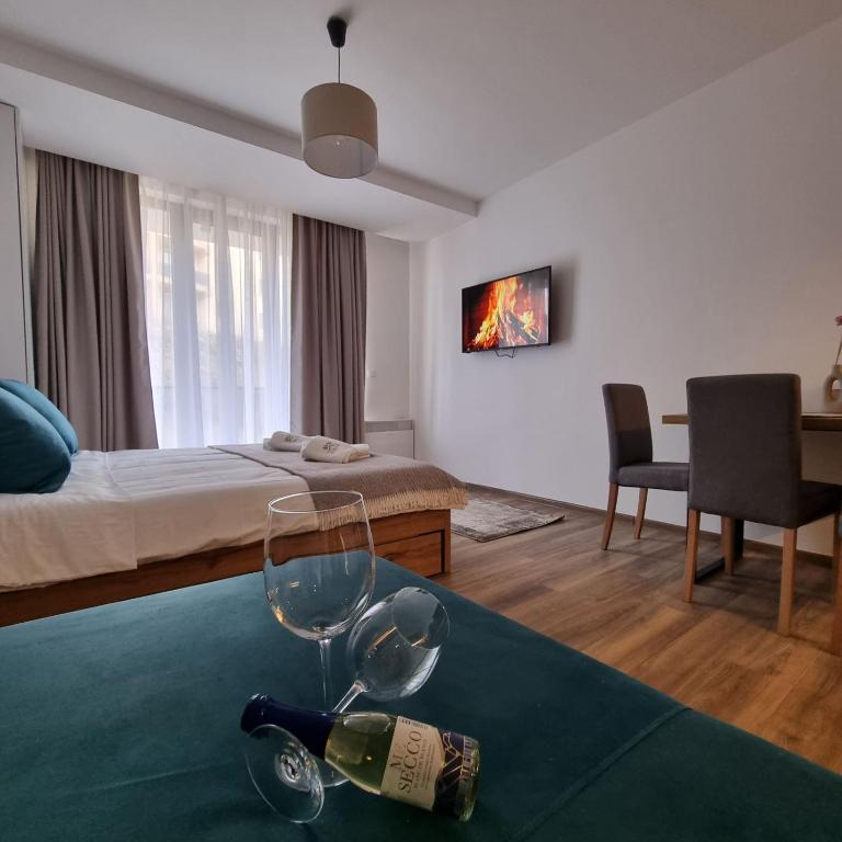 a hotel room with a bottle of wine on a table at SKYLINE apartments Kopaonik in Kopaonik