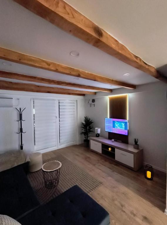a living room with a flat screen tv at Apartman Martinović in Županja