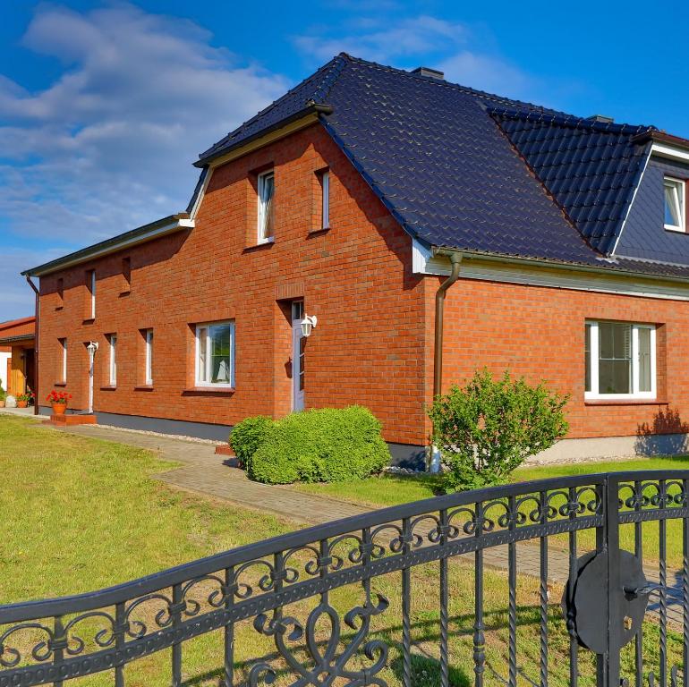 a red brick house with a black roof at Ferienhaus Herbert in Groß Kordshagen