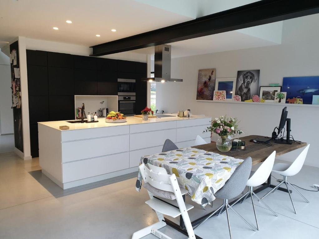a kitchen and dining room with a table and chairs at Tomorrowland2026 Basecamp in Mechelen