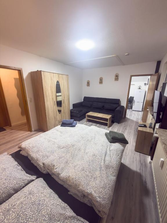 a living room with a large bed and a couch at HanseSuite zentral & charmante Ferienwohnung in Lübeck
