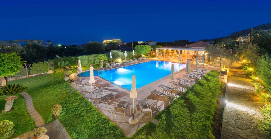 an overhead view of a swimming pool at night at Celestial Lindos Suites in Líndos