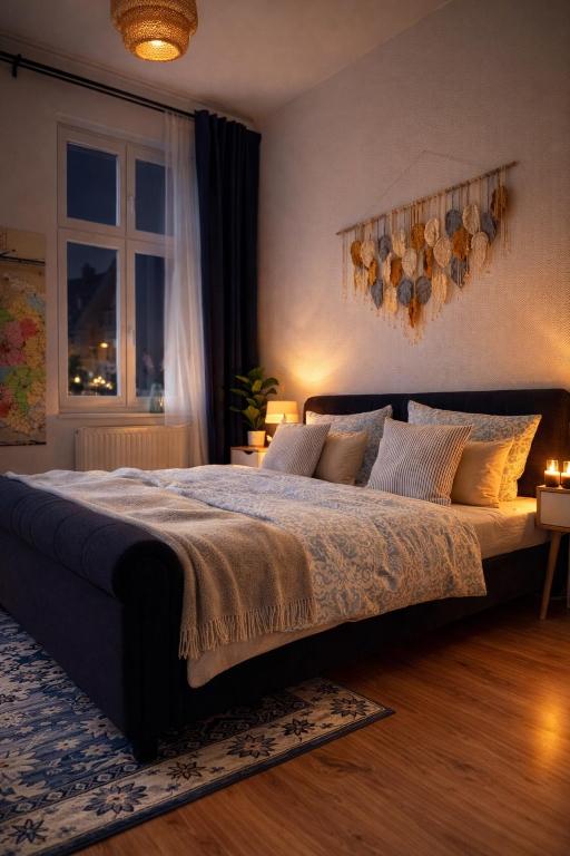 a bedroom with a large bed and a window at Stadtquartier Luckenwalde in Luckenwalde