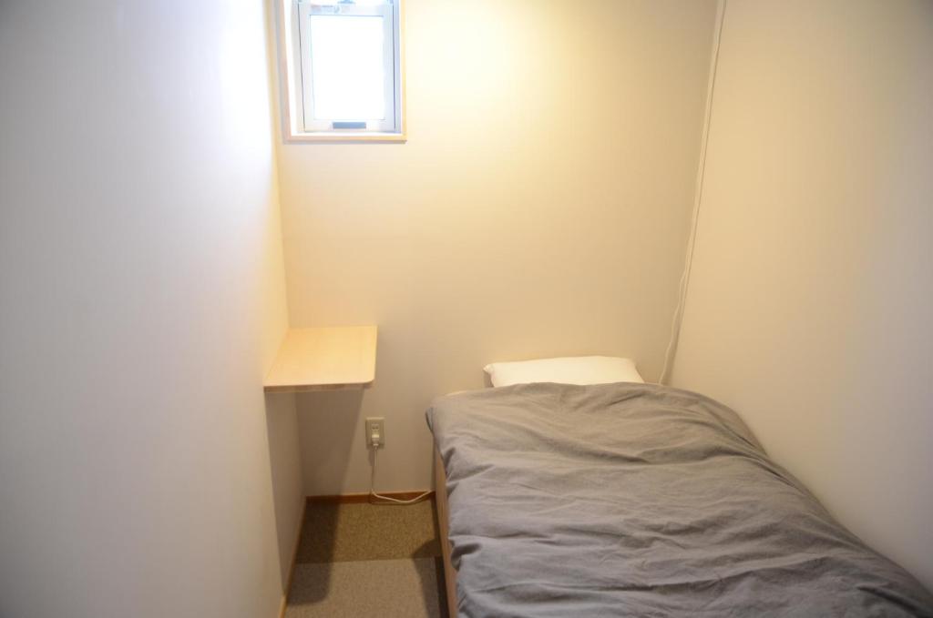 Postel nebo postele na pokoji v ubytování Sai no Tsuno Guest House