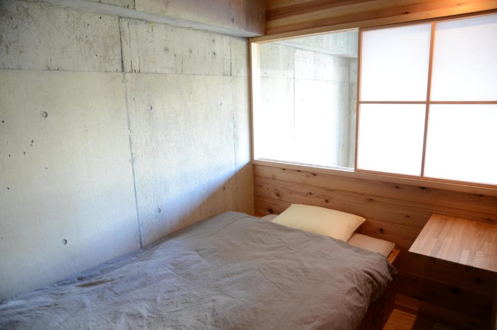 Postel nebo postele na pokoji v ubytování Sai no Tsuno Guest House