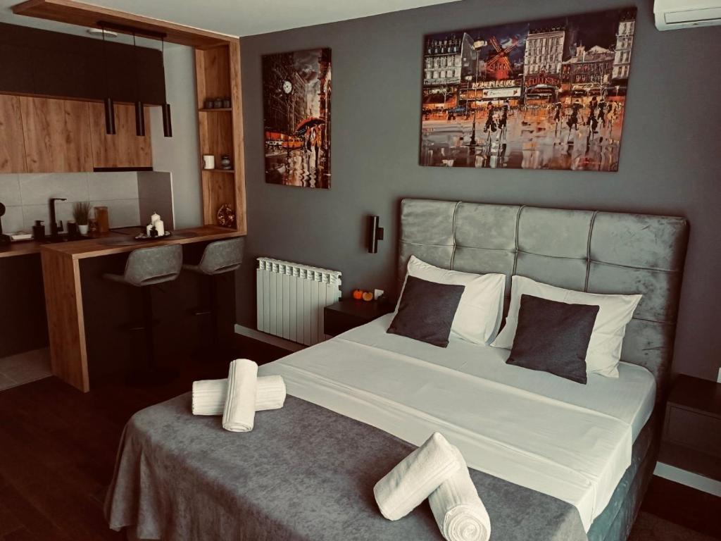 a bedroom with a large bed with white sheets at The Little Haven in Kragujevac