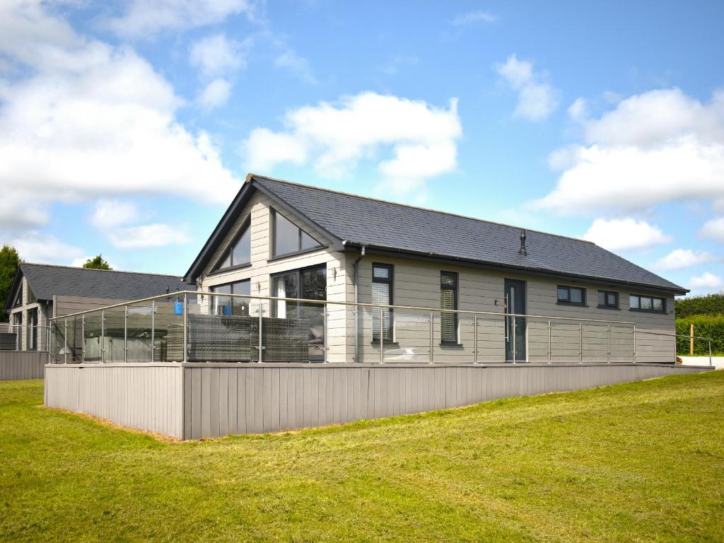 a house on a hill with a fence at Oak Park Two - Uk50063 in Tiverton
