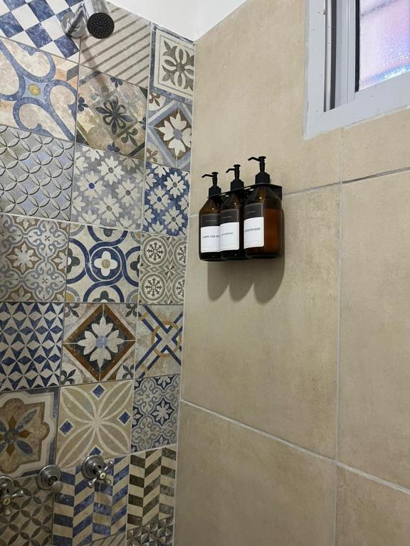 a bathroom with two soap bottles on the wall at Los dos Algarrobos in Villa Dolores