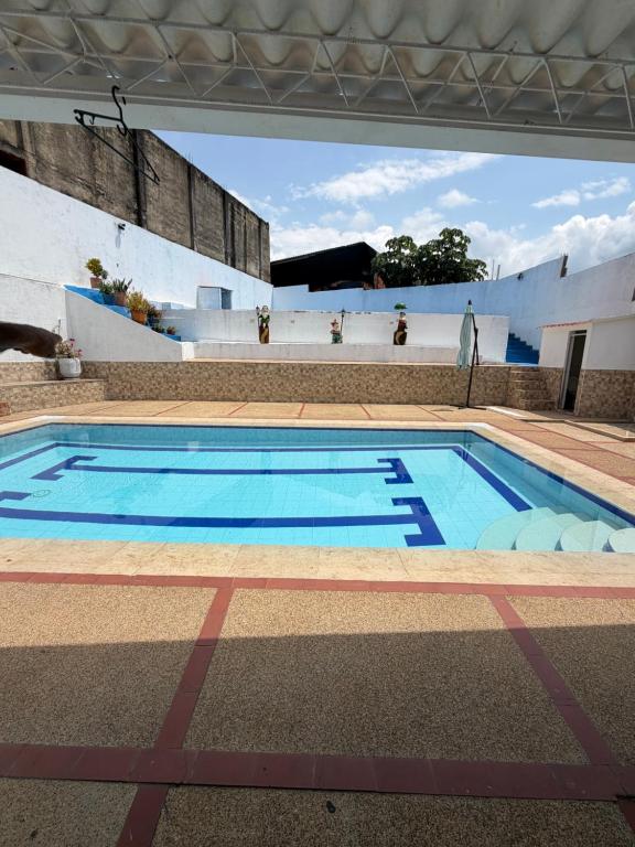 a large swimming pool in a building at Villa Alejandro in Melgar