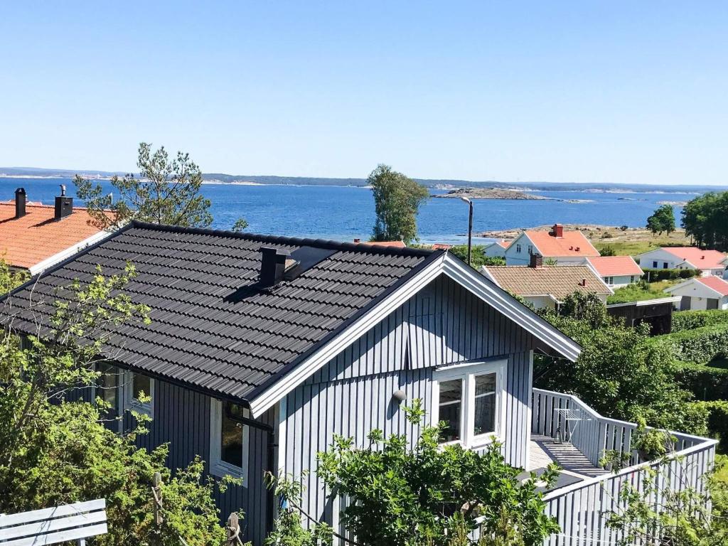 a house with a black and white roof at 4 person holiday home in Nordkoster in Strömstad
