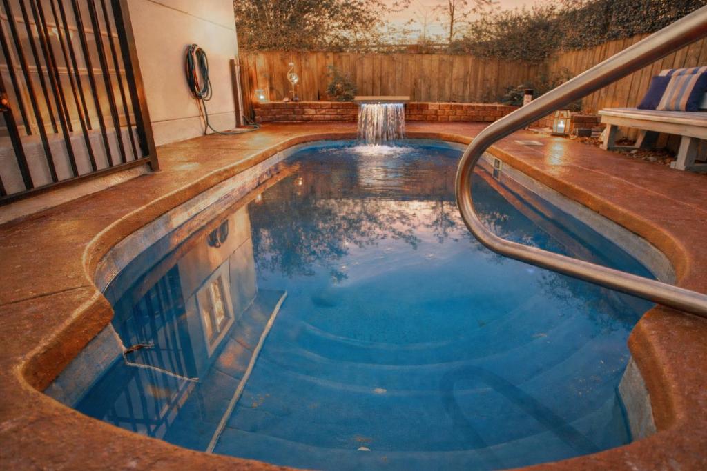 a swimming pool with a metal rail in a house at Pool house , near downtown SA in San Antonio