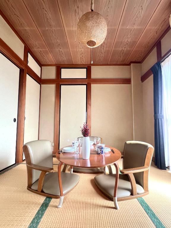 a dining room with a table and two chairs at Mami and Ko house in Kawaguchi