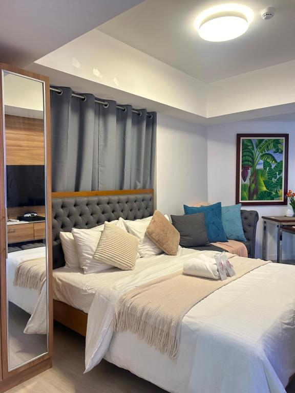 a bedroom with two beds and a mirror at Mekeni Azure Escape in San Fernando